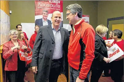  ?? ‘THE CANADIAN PRESS/ANDREW VAUGHAN ?? Nova Scotia Liberal Leader Stephen McNeil, right, chats with Labi Kousoulis, in Halifax on Oct. 7, 2013. Nova Scotia employers would have to provide up to 16 continuous weeks of unpaid leave for employees who are victims of domestic violence under...