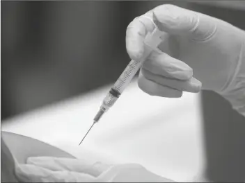  ?? ASSOCIATED PRESS ?? IN THIS JAN. 23, 2020 FILE PHOTO, a patient receives an influenza vaccine in Mesquite, Texas. On Wednesday, Alex Azar, the head of the U.S. Department of Health and Human Services, announced that pharmacist­s in all 50 states will be authorized to give childhood vaccinatio­ns this fall, due to a federal order that will temporaril­y preempt pharmacy restrictio­ns in 22 states.