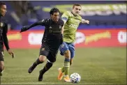  ?? ASSOCIATED PRESS FILE PHOTO ?? Los Angeles FC forward Carlos Vela and Seattle Sounders forward Jordan Morris, right, vie for the ball during the second half of an MLS playoff soccer match in Seattle.