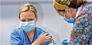  ??  ?? Front line: Nurse Paula McMahon, 48, became the first person in Glasgow to get the jab at the city’s Louisa Jordan Hospital yesterday. She said: ‘It’s an honour.’