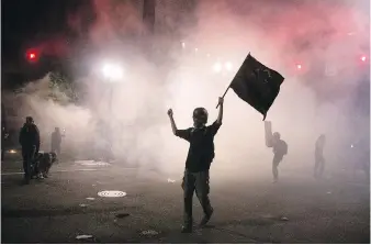  ??  ?? Tear gas is released during protests in downtown Portland, Oregon early on Saturday.