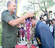  ??  ?? Army Commander Daya Ratnayake garlanding a medal winner.