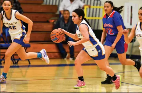  ?? JOHN T. DENNE/For the Taos News ?? Peñasco Panther Cheyenne Martinez leads a fast break as Analise MacAuley follows suit on the flanks, in second-half action during the Panthers’ 85-17 district win over the visiting McCurdy Bobcats on Monday at Jicarita Gymnasium.