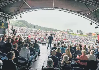  ?? ?? Listening to the speeches on the racecourse in 2019.