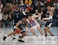  ?? TIM PHILLIS — FOR THE NEWS-HERALD ?? Benedictin­e’s Davin Zeigler looks to control the ball as VASJ’s Graham Koppleman defends on Jan. 11.