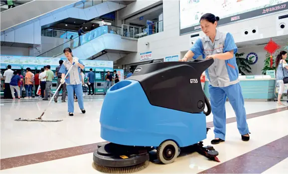  ??  ?? Cleaners carry out cleaning work at Tongling Municipal People’s Hospital. They work in public welfare posts developed by the Tongling City Human Resources and Social Security Bureau, Anhui Province.