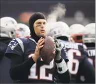  ?? Charles Krupa / Associated Press ?? In this Dec. 31, 2017, file photo, New England Patriots quarterbac­k Tom Brady keeps limber on the sideline in the cold weather during the first half against the New York Jets, in Foxborough, Mass.