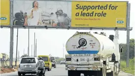  ?? Picture: AFP ?? NOT CHEAP: Motorists drive under a MTN billboard on the Lagos-Ibadan expressway. MTN is in frantic talks to reduce a $5.2-billion fine imposed by Nigeria's telecoms regulator