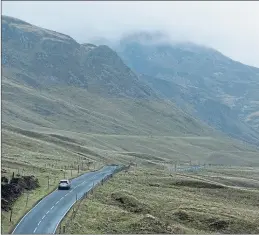  ??  ?? Low cloud as a car makes it way towards Glenshee