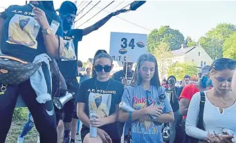  ?? JiM MicHaud / BOSTOn HeRald ?? PRAYERS: A prayer is said before the march down Mount Vernon Street in Dedham on Sunday.