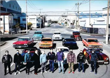  ?? AFP ?? Car owners poses for a photo during a gathering of auto enthusiast­s in Urayasu, an eastern suburb of Tokyo.