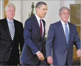  ?? AP file photo ?? Then-President Barack Obama walks out of the Oval Office with former Presidents Bill Clinton and George W. Bush at the White
House in Washington in 2010. Three former presidents say they’d be willing to take a coronaviru­s vaccine publicly to encourage all Americans to get inoculated against the deadly disease.