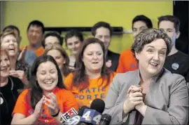  ?? Photograph­s by Allen J. Schaben Los Angeles Times ?? KATIE PORTER is applauded by volunteers at her first news conference after being declared the winner over Mimi Walters in the 45th Congressio­nal District.