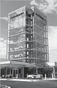  ?? THE OKLAHOMAN FILE ?? The Carvana car vending machine at 1800 W. Memorial Road. The company is building a huge reconditio­ning and inspection center in southwest Oklahoma City.