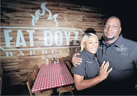  ?? JOHN MCCALL/SUN SENTINEL ?? Fat Boyz Barbecue owners Jarael Holston-Jones and wife Yolanda at their restaurant in Coral Springs in 2019. The Coral Springs location closed this week.