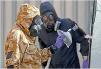  ?? Reuters file ?? Forensic investigat­ors emerge from the rear of John Baker House, after it was confirmed that two people had been poisoned with the nerve-agent novichok, in Amesbury. —