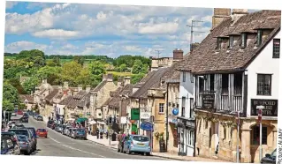  ??  ?? Vibrant: Shops and restaurant­s line Burford High Street in the Cotswolds