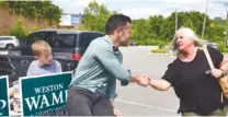  ?? STAFF PHOTO BY ROBIN RUDD ?? Hamilton County mayoral candidate Weston Wamp greets voter Heather Ericson before she goes into vote in Tuesday’s primary election at Rivermont Presbyteri­an Church.