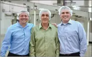  ?? COURTESY OF JUSTIN SPANNUTH ?? Justin Spannuth, chief operating officer of Unique Snacks, with his father and brother outside of Unique’s plant in Muhlenberg Township, Berks County. From left: Bill Spannuth Jr., Bill Spannuth Sr. and Justin Spannuth.