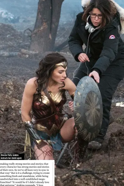  ??  ?? Director Patty Jenkins instructs her shield agent.