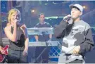  ??  ?? On stage with Eminem in 2000.