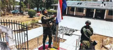  ?? Reuters ?? ↑
A soldier of the Karen National Liberation Army raises Karen’s national flag at Myawaddy military base in Myanmar on Monday.