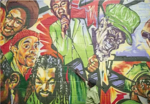  ?? BRIAN B. BETTENCOUR­T/TORONTO STAR ?? Musican Jay Douglas was immortaliz­ed in the mural on Reggae Lane in Little Jamaica. The new area honours Toronto’s place in reggae music.