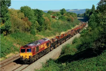  ?? (Martin Loader) ?? BELOW: In desperate need of a repaint, a tatty 66169 passes Up Hatherley, on the outskirts of Cheltenham, with the 6V92 1028
Corby to Margam on September 18, 2019. Ten of the now de-hooded JSAs can be discerned in the formation, interspers­ed with a similar number of BZAs (cradlefitt­ed ex-BAA steel wagons), which are available in OO gauge from Bachmann. The interiors of the JSAs show the scars of carrying the hot coils, with rust and scorching much in evidence.