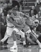  ?? ASSOCIATED PRESS ?? CHARLOTTE HORNETS FORWARD Marvin Williams (right) drives into Phoenix Suns guard Elfrid Payton in the first half of Saturday’s game in Charlotte, N.C.