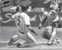  ?? Canadian Press photo ?? Toronto Blue Jays' Troy Tulowitzki gets tagged out sliding into home by Oakland Athletics' Bruce Maxwell during the seventh inning of MLB baseball action in Toronto, Thursday.