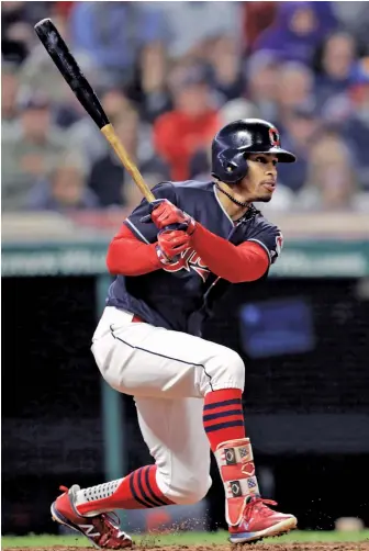  ?? AP PHOTO ?? IN THE SWING: Francisco Lindor hits an RBI single off Red Sox starter Rick Porcello during the second inning of the Indians’ 5-4, 11-inning victory last night in Cleveland. The Sox failed to clinch home-field advantage throughout the postseason.