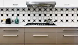  ?? KATHERINE FREY The Washington Post ?? There are primarily two ways to add a little spice to this classic backsplash. The first is by deviating from the gloss white; the second is by deviating from the installati­on pattern on the wall.