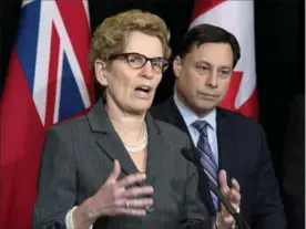  ?? FRANK GUNN, THE CANADIAN PRESS ?? Premier Kathleen Wynne with cabinet minister Brad Duguid in March 2014.