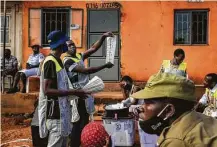  ?? Jerome Delay / Associated Press ?? Voting officials count the ballots after polls closed Thursday in Kampala, Uganda, in the nation’s presidenti­al election.