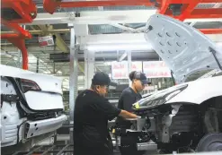  ??  ?? Some tasks require the human touch, but Model 3 production remains heavily, strikingly automated, with robots handling body assembly.