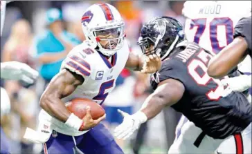  ?? KEVIN C COX/GETTY IMAGES/AFP ?? Buffalo Bills quarterbac­k Tyrod Taylor (left) slips away from Grady Jarrett of the Atlanta Falcons in the second half of their game at Mercedes-Benz Stadium on Sunday in Atlanta, Georgia.