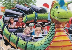  ?? PAUL FORSYTH METROLAND ?? Dione McSpadden, on the left at front, is all smiles as she rides the Dragon Wagon at the Niagara Falls Carnival at Firemen’s Park Friday night. The 67th annual event wrapped up on Saturday.