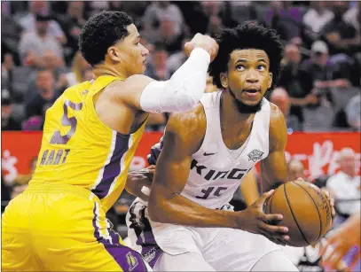  ?? Rich Pedroncell­i ?? The Associated Press Sacramento’s Marvin Bagley III, right, drives against Lakers guard Josh Hart in a summer clash Monday in Sacramento, Calif.
