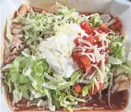  ?? PHOTOS PROVIDED BY GRUB SCOUT/SPECIAL TO THE NEWS SENTINEL ?? The enchiladas supremas consist of one each of chicken, beef, cheese and bean. They’re served with salsa, lettuce and sour cream on top and rice and beans on the side.