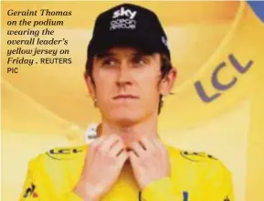  ?? PIC REUTERS ?? Geraint Thomas on the podium wearing the overall leader’s yellow jersey on Friday .