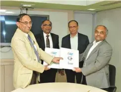  ??  ?? D.K. Venkatesh, Director (Engg. and R&D), HAL (extreme left), and Dr A.T. Kalghatgi, Director (R&D), BEL, exchanging the MoU documents in the presence of T. Suvarna Raju, CMD of HAL (second from left) and S.K. Sharma, CMD of BEL.