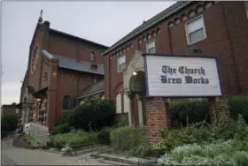  ?? DAKE KANG — THE ASSOCIATED PRESS ?? At the Church Brew Works, an early church-turned-brewery that opened in 1996, patrons slide into booths crafted from pews.