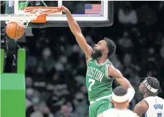  ?? USA TODAY SPORTS ?? Celtics guard Jaylen Brown dunks against the Magic during the second half at the TD Garden.