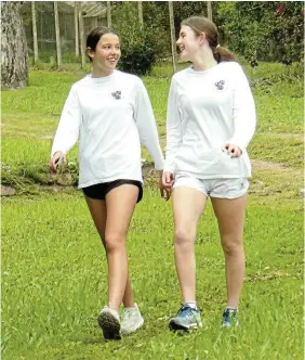  ?? ?? HAPPY HOUR: Walking downhill on the undulating Makana Botanical Gardens parkrun course, Diocesan School for Girls (DSG) grade 9 pupils Allegra Goedhart (left) and Amy Page have time for a chat and a chuckle during a recent Saturday staging of the weekly event. Parkruns are held each Saturday at 8am from the entrance to the botanical gardens in Lucas Avenue. Parkruns cater for runners, joggers and walkers of all ages.