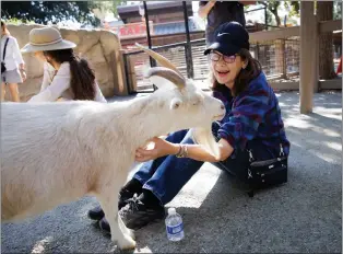  ?? PHOTOS BY DAI SUGANO — STAFF PHOTOGRAPH­ER ?? Senior Safari program participan­t Ginny Barret, 70, of San Jose reacts as she pets a goat at Happy Hollow Park & Zoo in San Jose on Sept. 22. The Senior Safari program at the park, which drew about 500partici­pants, aims to combat social isolation by getting older adults out to the park for a fun day of zoo tours, animal meet-and-greets, amusement rides and other activities. The next Senior Safari will be Oct. 27.