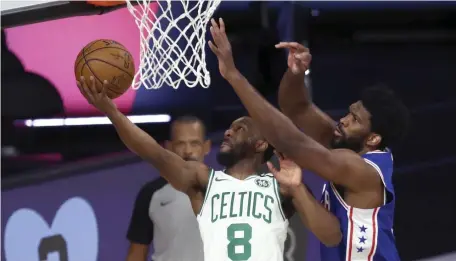  ?? GEtty IMagEs ?? GOING UP: Kemba Walker goes up for a shot while being defended by Joel Embiid during Sunday’s Game 4.