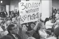  ?? Jerry Lara / Staff photograph­er ?? Isabel Zepeda with the Southwest Workers Union shows her support for a citywide paid sick leave ordinance.