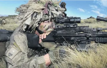  ?? PHOTOS: JOHN COSGROVE ?? Supporting role . . . Private Bryn McLeodJone­s, a Port Otago cargo handler, lines up his next target while manning the 7.62mm light support weapon, in a fire support role during the New Zealand Army reserve force training exercise held at Tekapo.