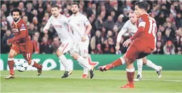  ??  ?? Coutinho (right) scores the first goal from a penalty during the UEFA Champions League Group E match between Liverpool and Spartak Moscow at Anfield in Liverpool, north-west England. — Reuters photo