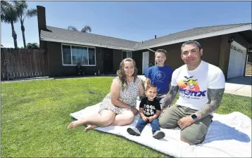  ?? PHOTO BY WILL LESTER ?? Daniel and Rio Baeza relax outside their Ontario home with their children, Logen, 14, and Collin, 18 months, on June 4. The family, who had been renting a condo, decided to join the bidding wars taking place in the region’s housing market.